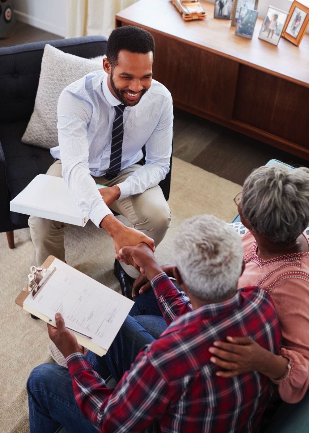 senior-couple-shaking-hands-with-male-financial-ad-8EXRPDY.jpg